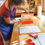 Artist Jennifer Pentrack prepares a print for the show.