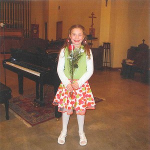Lillie, smiling after completing her first-ever piano recital. Lillie received a piano with the assistance of Redding Piano Angels.