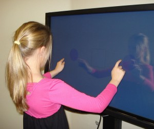 Ryleigh improves her eye-hand coordination with the Sanet Vision Integrator's touchscreen.