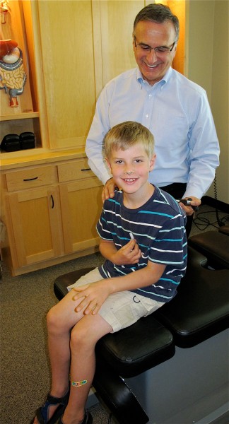 Dr. Patrick Giammarise works with a young patient David at the Digestion Relief Center in Chico. 