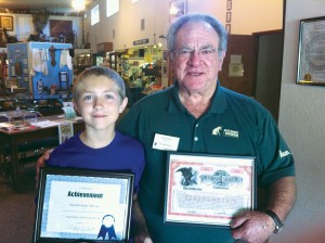 Austin receiving an award from Paradise Depot Museum Curator Tim McGrath.