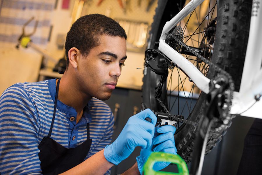 teenager working on bikes - north state parent