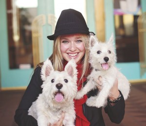 Pet Safety - a woman holding 2 small white dogs - north state parent