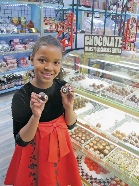 a girl having sweets to eat in a candy store