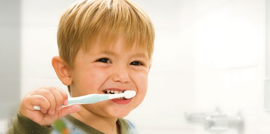 Improving Oral Health - a kid brushing his teeth - north state parent