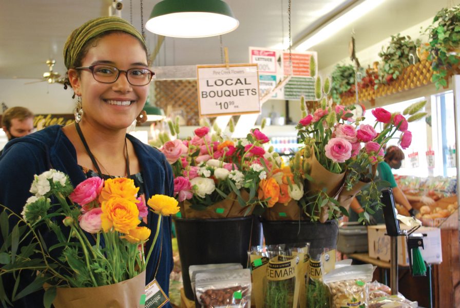 a girl holding Pine Creek Flowers at S&S Organic Produce and Natural Foods