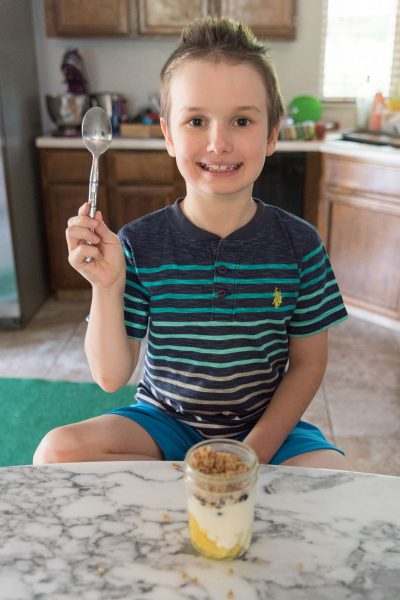 breakfast - a kid eating Yogurt Parfaits