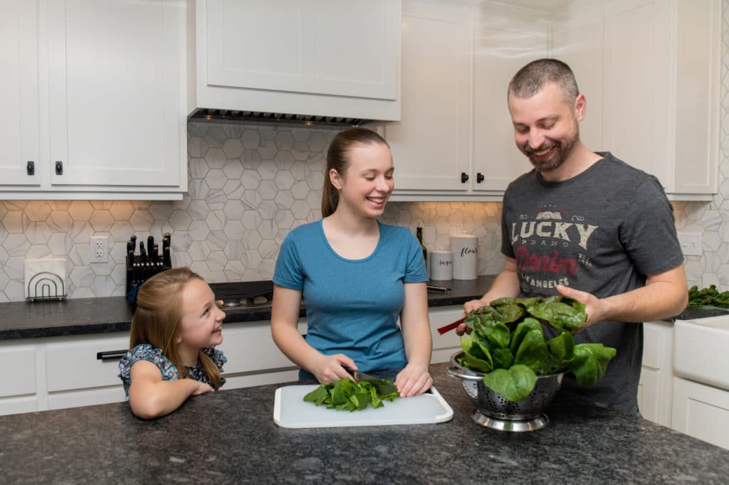 a family preparing greens to boost their Immune System - north state parent