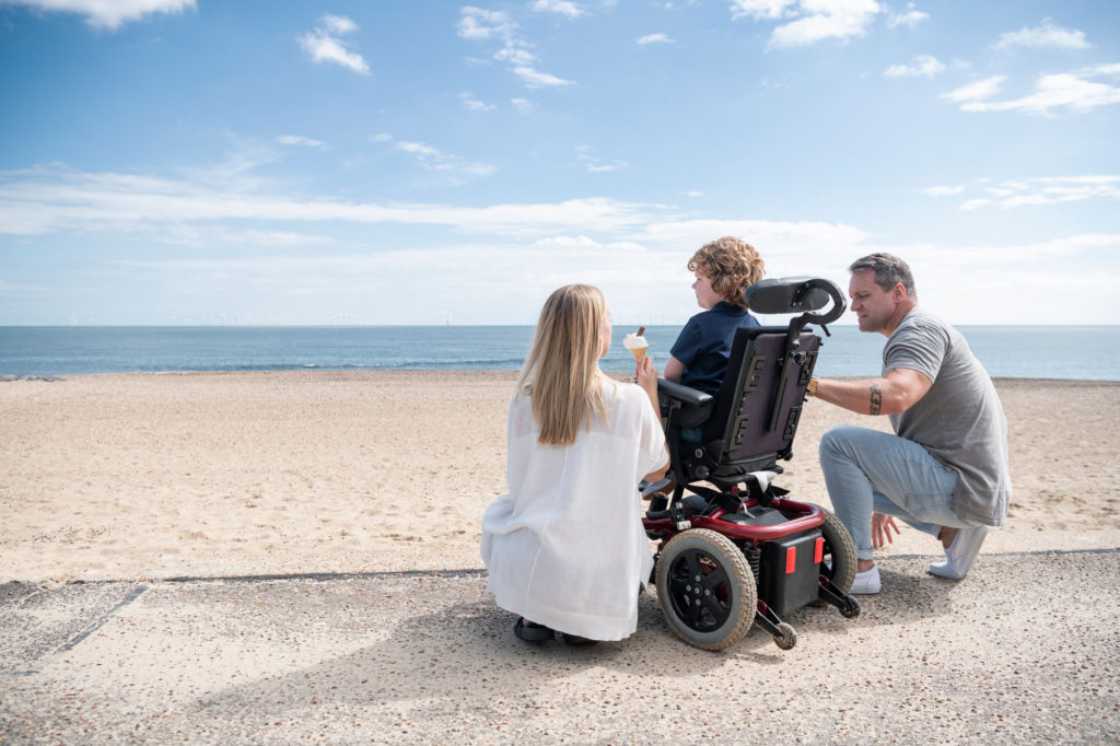 A special needs family at the beach thinking about Financial Planning for Children With Special Needs