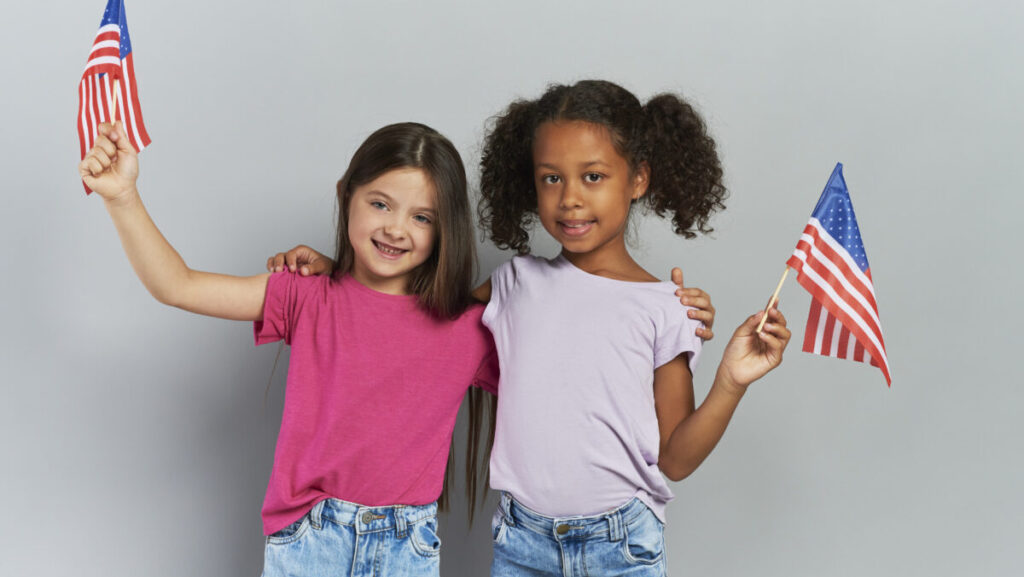 Two girls holding American flag