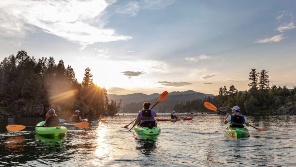 Family sea kayaking on Flathead Lake in Somers, Montana, USA (MR)