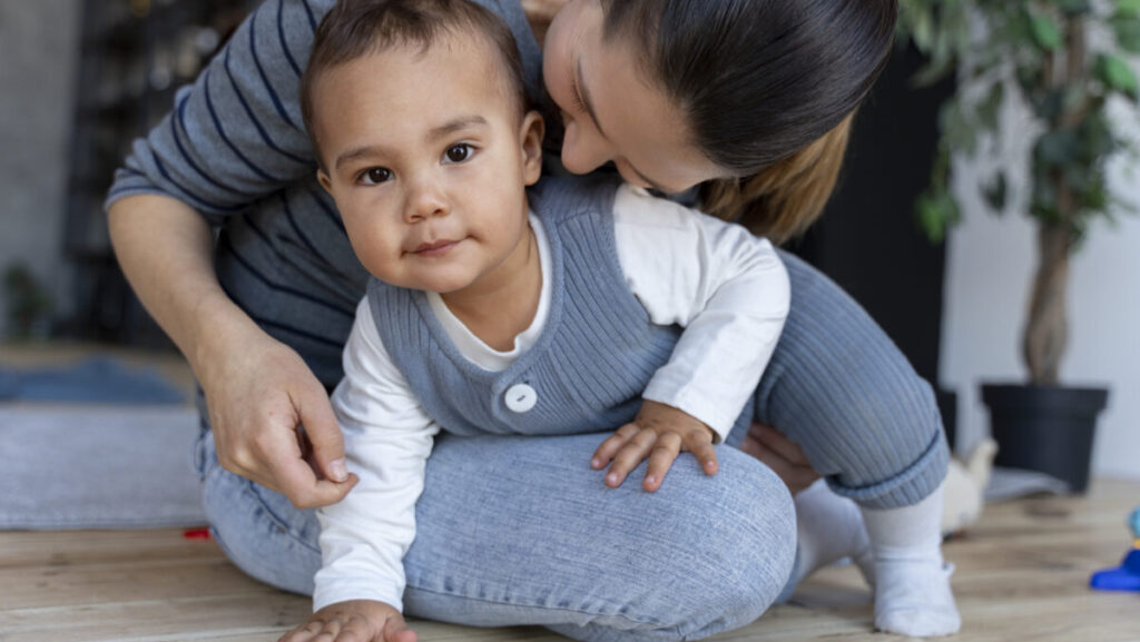 adorable-baby-crawling-his-mother-s-lap