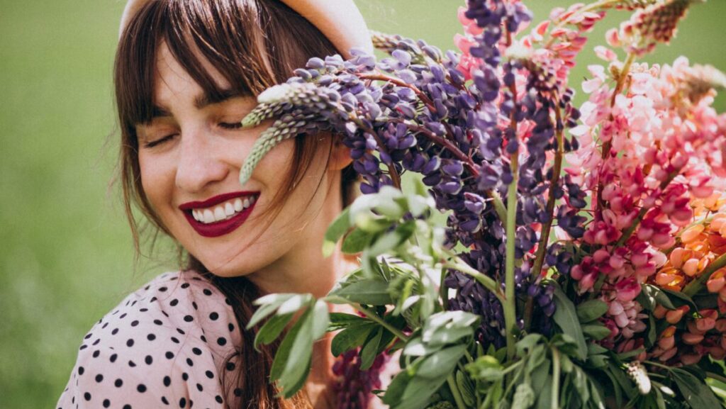 Woman walking in a field with lupinuses