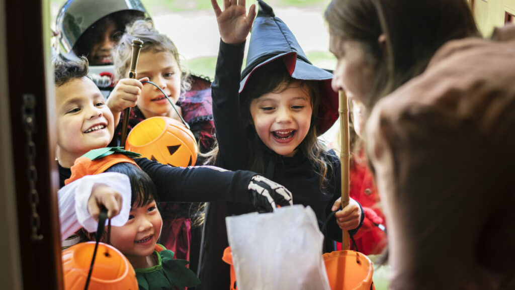 Little children trick or treating on Halloween