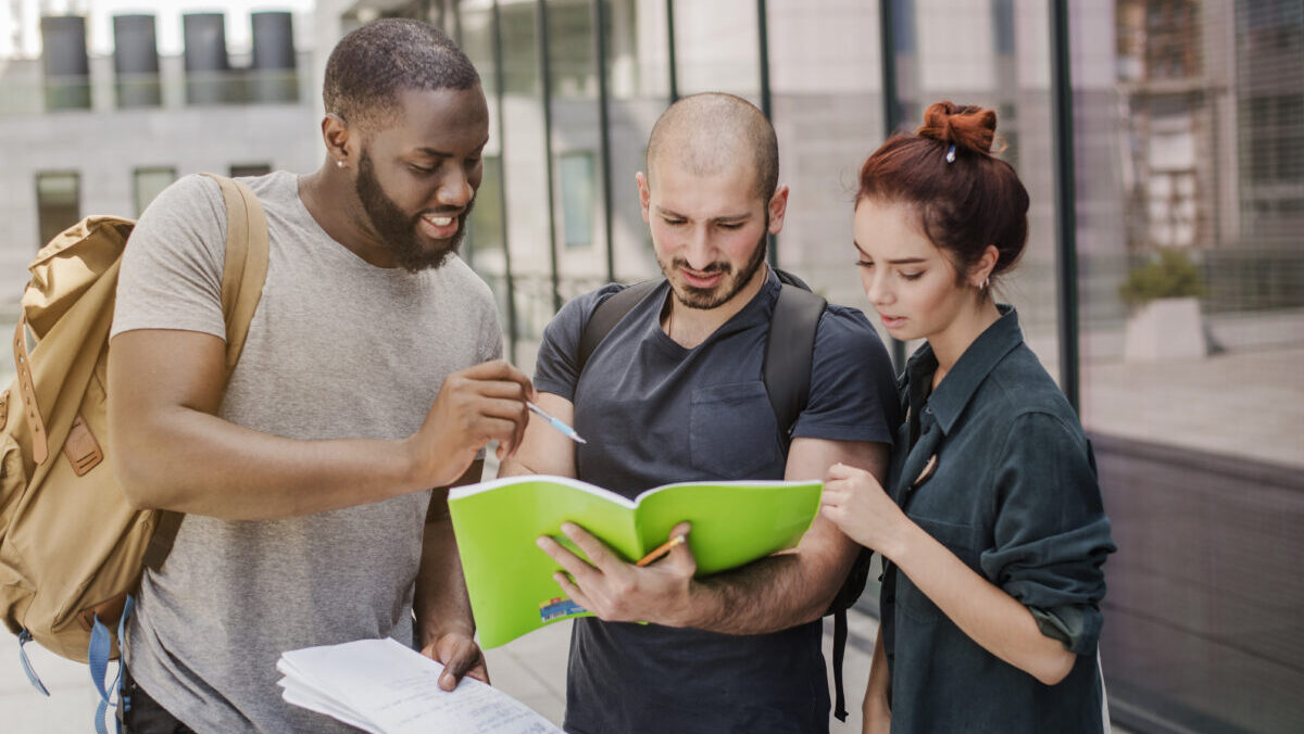 people-standing-with-papers-outdoors