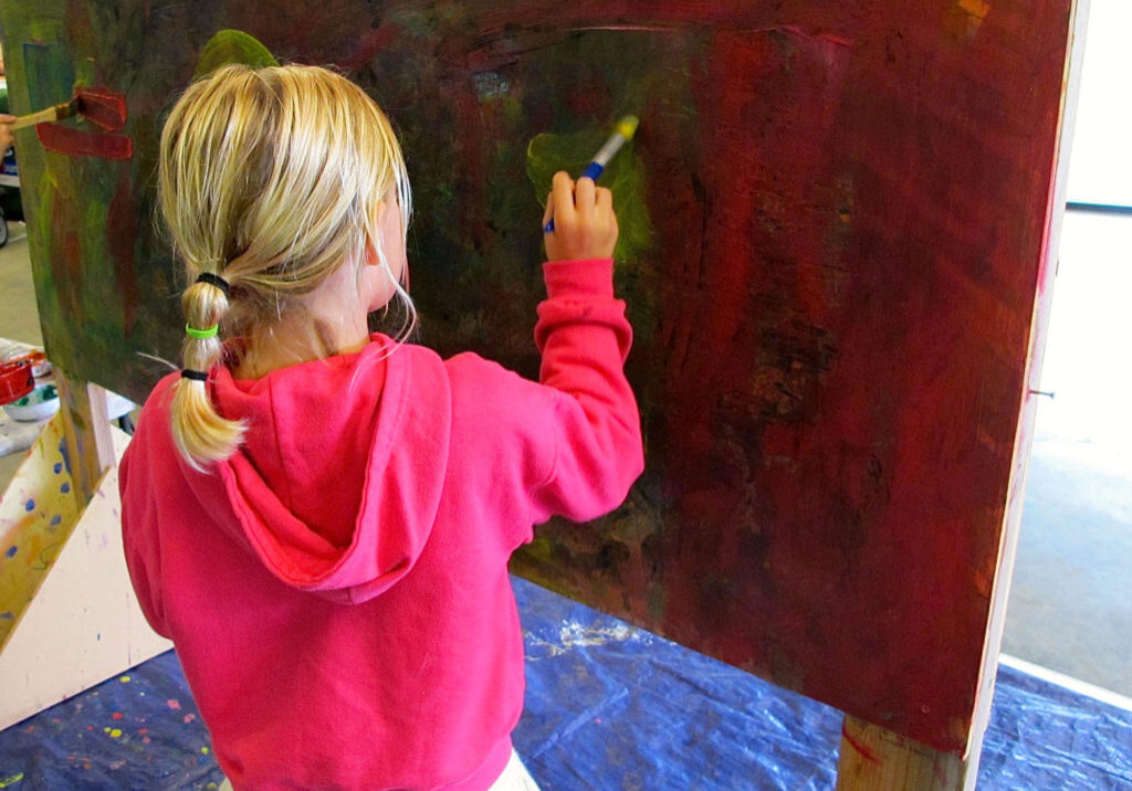 a young child painting art - north state parent