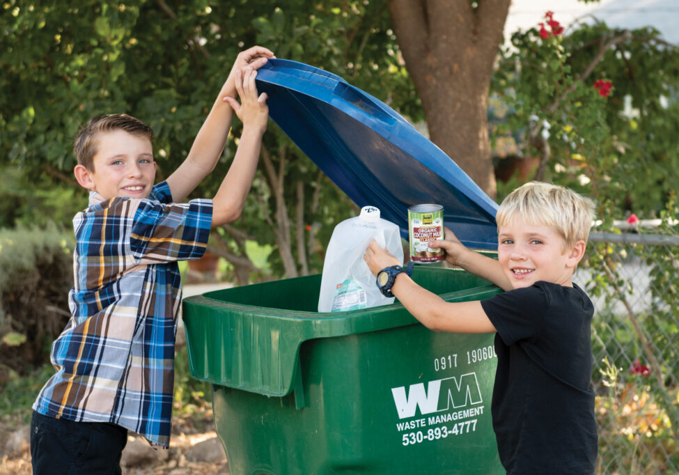 Weston, age 8;  and Miles, age 6 help their family with recycling. 
Photo by Amber Thompson.