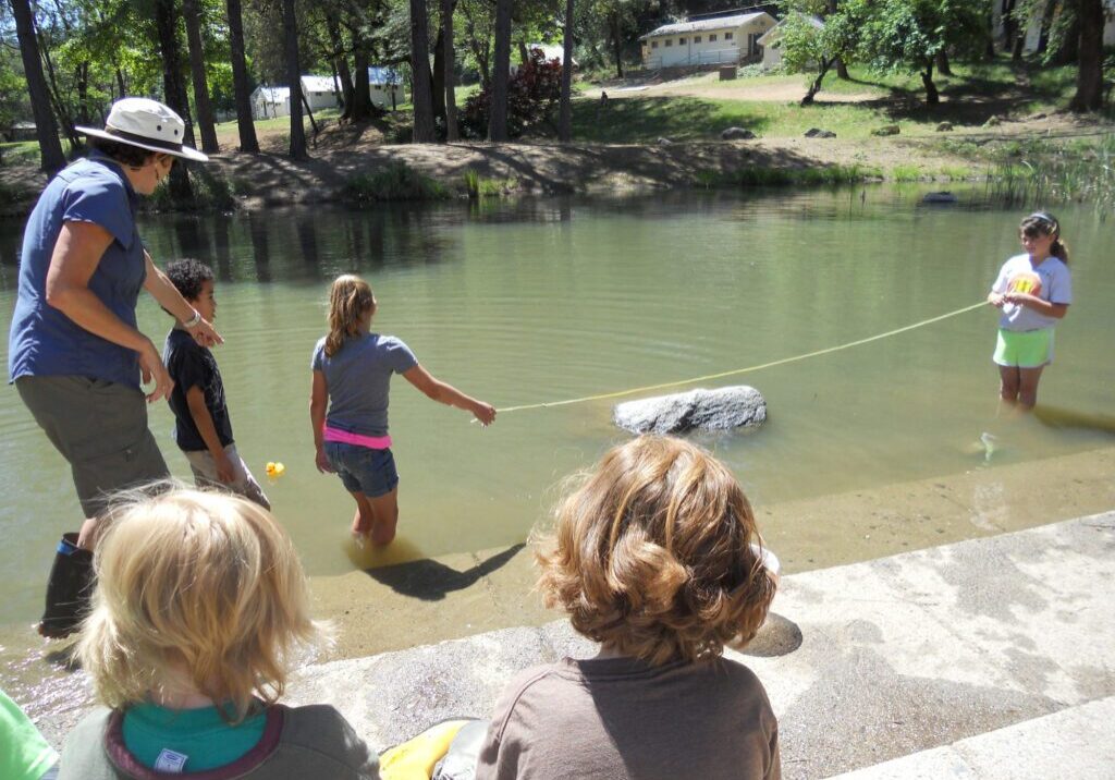 Columbia Elementary school students learn to measure pond water levels at WES camp in 2013.
