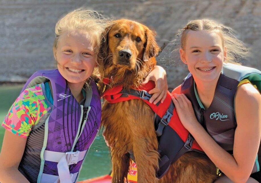 Leo is a true part of the Murray family, enjoying a day on the lake with her people: Hannah, 11; and Megan, 14. Photo by Amber Murray.