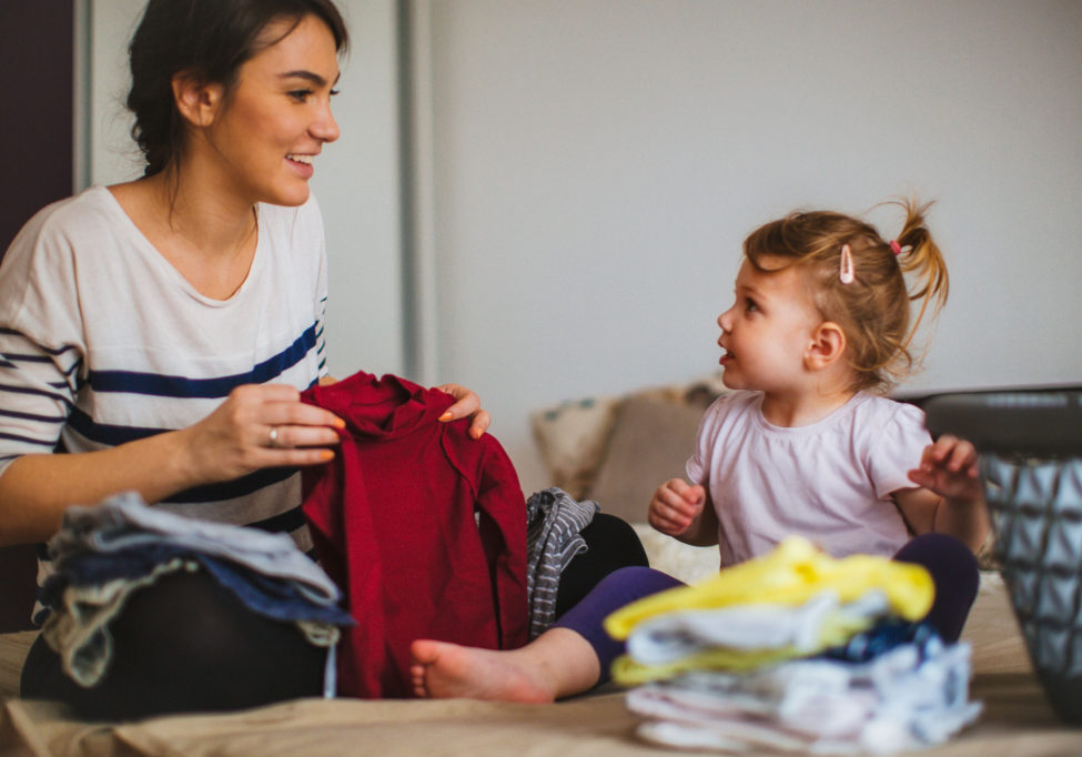 Toddlers can start learning independence by helping with simple chores, like folding laundry.