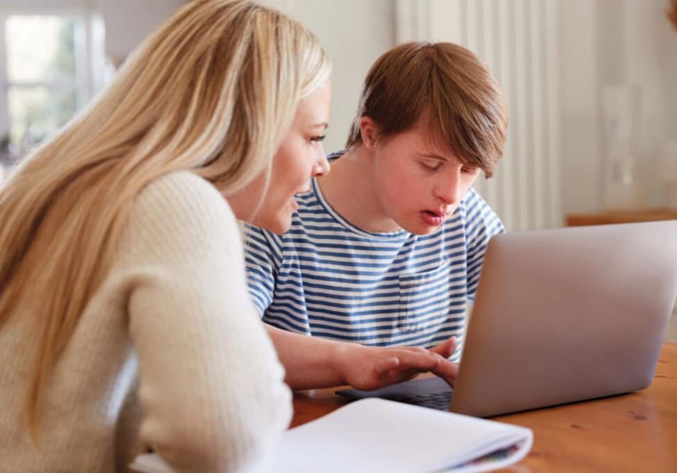 Mom helping son learn - Homeschooling a Child with Special Needs