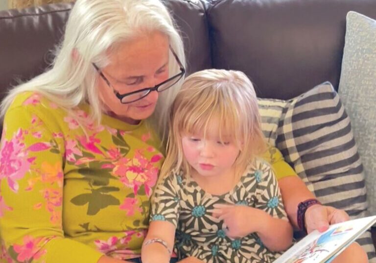 Zamora learns a love of reading and literacy as her grandma, Angela Beem, joyfully reads with her.
Photo credit Joann Goble.