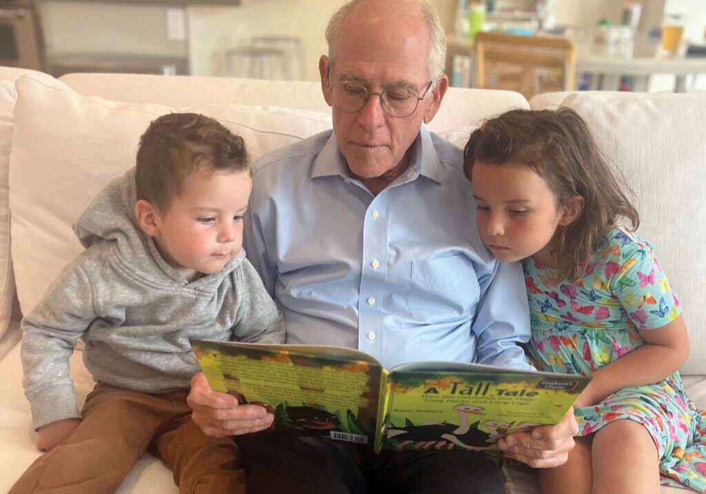 Scott Sollers, award-winning author of <em>A Tall Tale: How the Ostriches Got Their Long Necks and Long Legs</em>, enjoys reading with his beloved grandchildren.