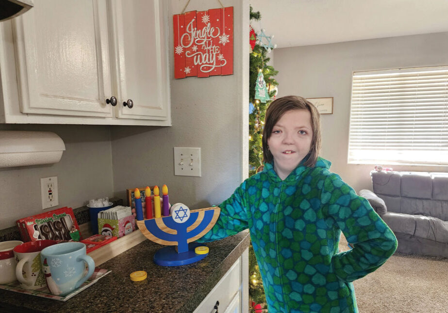 This visual and tactile representation of the menorah helps Lily Arnold to learn about Hanukkah. Photo by Jennifer Arnold.