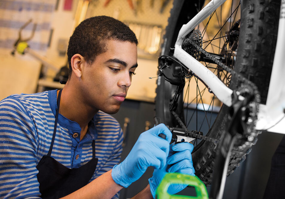 teenager working on bikes - north state parent